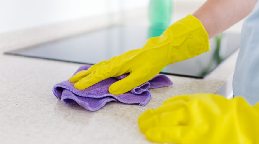 Woman's,Hands,Cleaning,Granite,Kitchen,Top,In,Rubber,Gloves,,Housekeeping